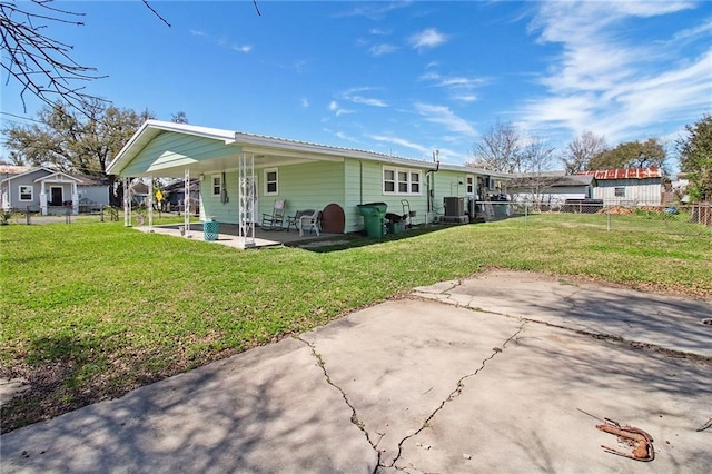 rear view of property with a patio, a lawn, fence, and central air condition unit