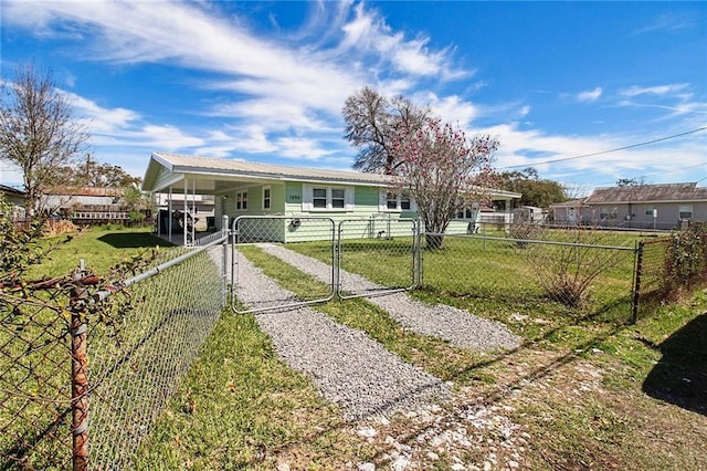 view of front facade with an attached carport, a fenced front yard, driveway, a gate, and a front lawn