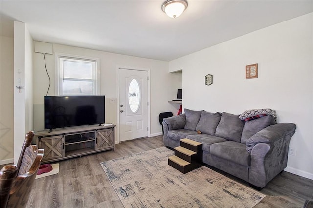 living room with baseboards and wood finished floors