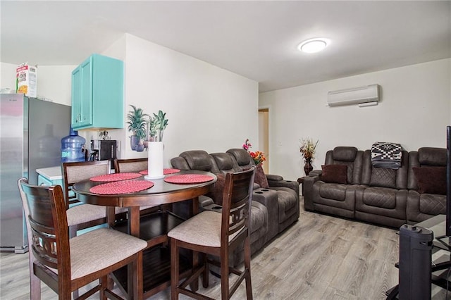 dining area with light wood-type flooring and a wall mounted air conditioner