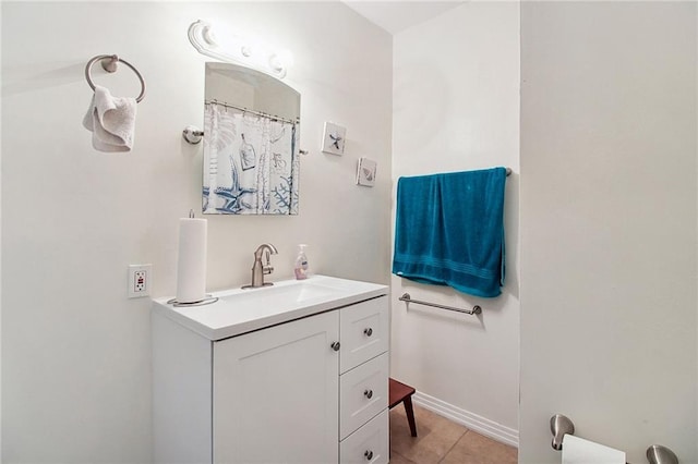 full bath featuring tile patterned flooring, vanity, and baseboards