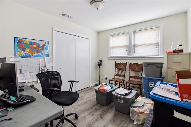 office with visible vents and wood finished floors