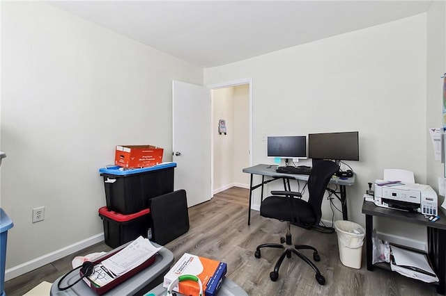 home office featuring wood finished floors and baseboards