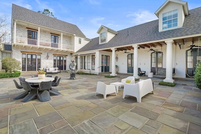 view of patio / terrace with a ceiling fan, a balcony, outdoor lounge area, and french doors