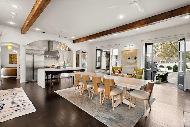 dining room featuring dark wood-type flooring, beam ceiling, recessed lighting, and arched walkways