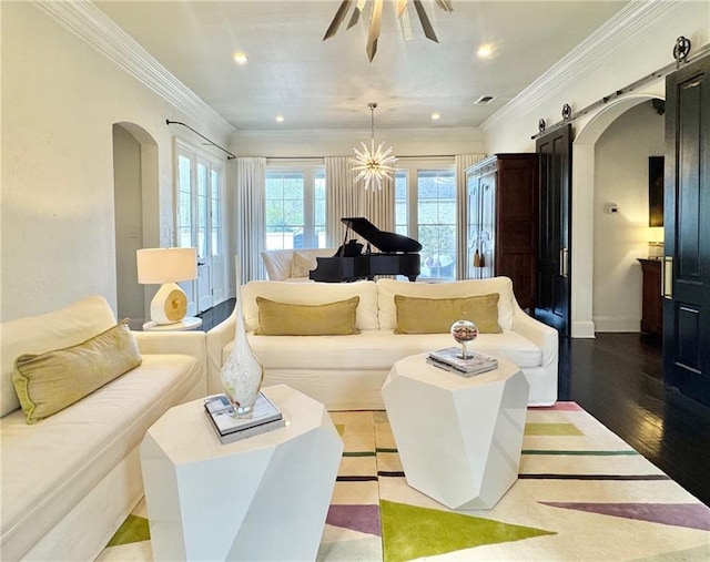 living area with recessed lighting, a barn door, ceiling fan, arched walkways, and wood finished floors