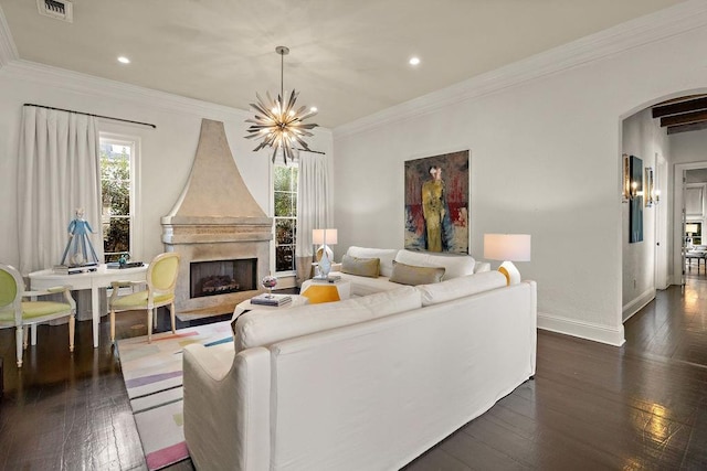 living room with arched walkways, a fireplace, ornamental molding, and plenty of natural light