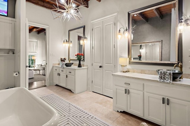 full bath with beam ceiling, a notable chandelier, tile patterned flooring, a soaking tub, and vanity