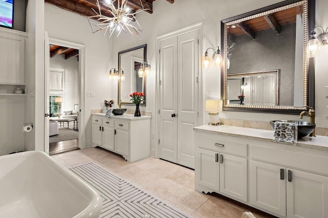 full bathroom featuring a freestanding bath, vanity, tile patterned flooring, and beam ceiling