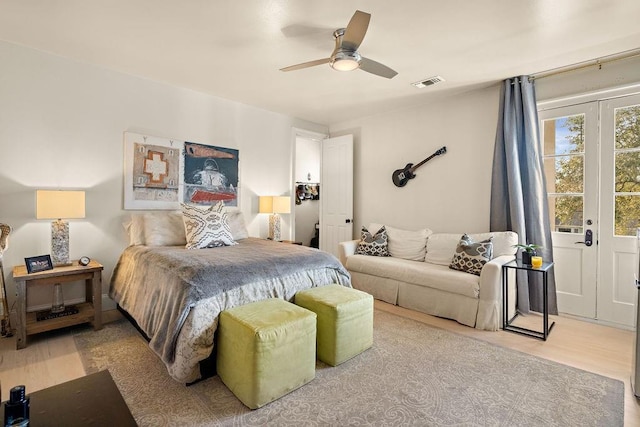 bedroom featuring visible vents, ceiling fan, and wood finished floors