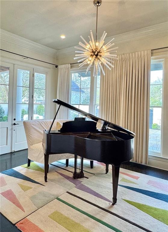 sitting room with crown molding, french doors, and a notable chandelier