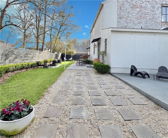 view of home's community with a patio area, fence, and a lawn