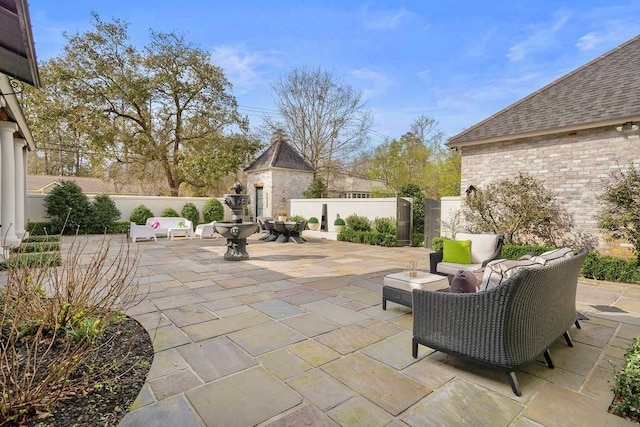 view of patio / terrace featuring an outdoor living space and fence