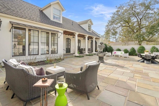 view of patio featuring outdoor lounge area and fence