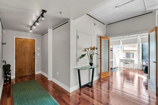 909 Lafayette St Unit 6, New Orleans, LA 70113 - entryway featuring rail lighting, wood finished floors, and baseboards