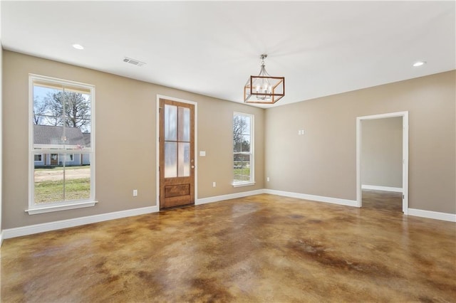 interior space with a healthy amount of sunlight, visible vents, baseboards, and concrete flooring