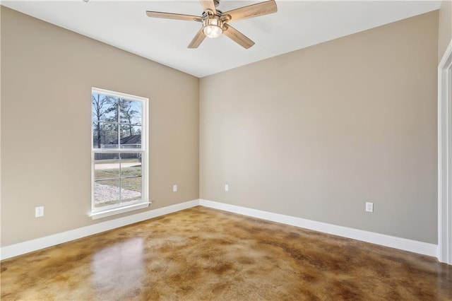 carpeted empty room with a ceiling fan and baseboards