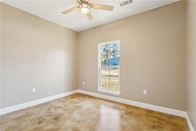 spare room with a ceiling fan, visible vents, and baseboards