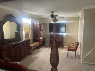 sitting room featuring ceiling fan, baseboards, crown molding, and light colored carpet