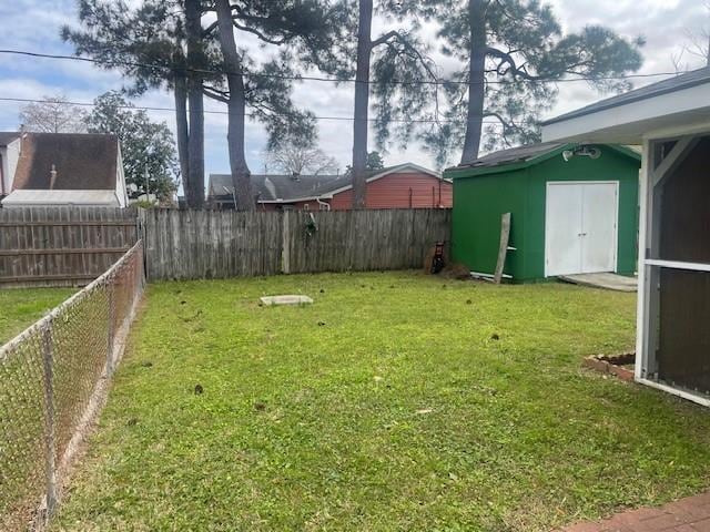 view of yard featuring a fenced backyard, a shed, and an outdoor structure