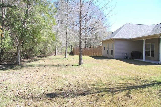 view of yard featuring fence and a patio