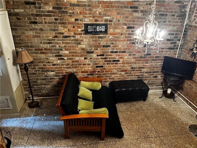 unfurnished living room featuring a chandelier, brick wall, and visible vents