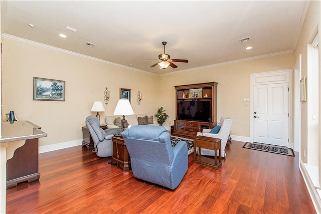 living area featuring dark wood-style floors, visible vents, ornamental molding, a ceiling fan, and baseboards