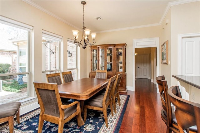 dining area featuring dark wood-style floors, visible vents, an inviting chandelier, ornamental molding, and baseboards