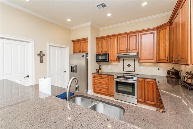 kitchen featuring stainless steel appliances, stone countertops, a sink, and under cabinet range hood