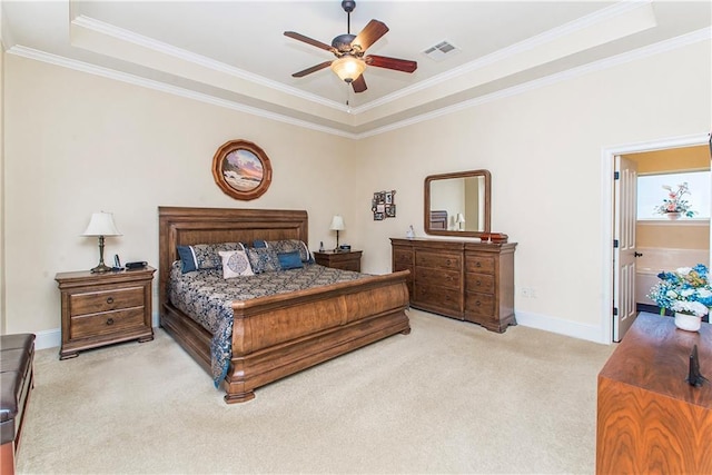 bedroom featuring crown molding, a raised ceiling, light colored carpet, visible vents, and baseboards