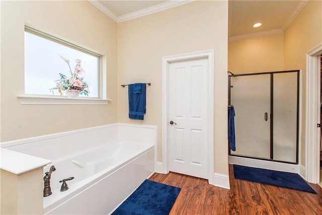 full bathroom featuring baseboards, wood finished floors, crown molding, a shower stall, and a bath