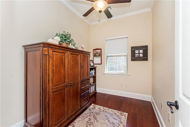 interior space with a ceiling fan, baseboards, dark wood finished floors, and crown molding