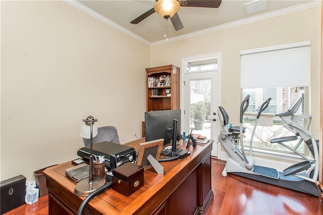 office area with dark wood-style floors, visible vents, crown molding, and a ceiling fan