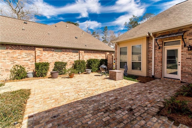 view of patio featuring a grill and fence