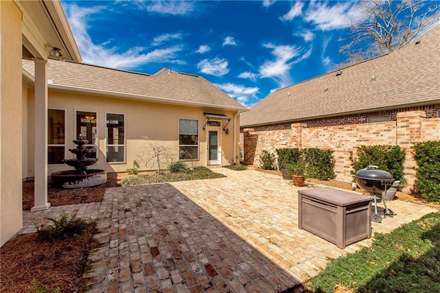 view of patio with a grill and fence