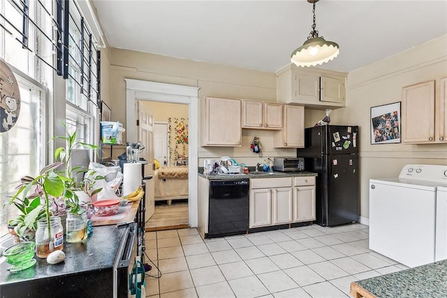 kitchen featuring black appliances, hanging light fixtures, light tile patterned flooring, and a sink