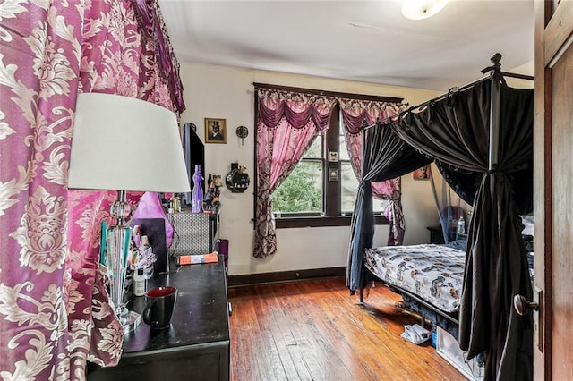 bedroom featuring wood-type flooring and baseboards