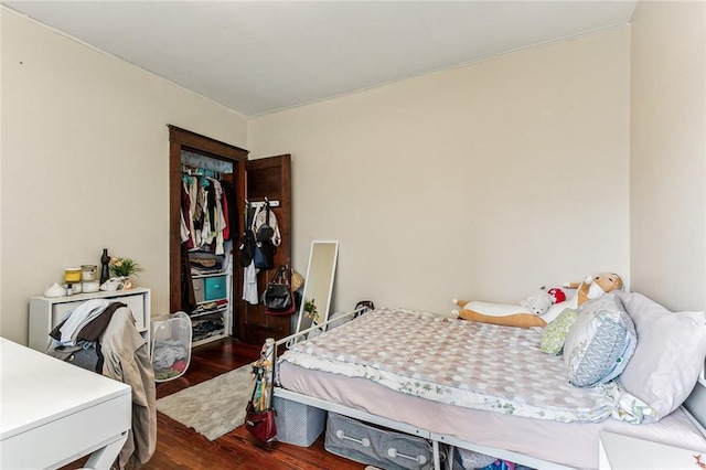 bedroom with a closet and wood finished floors