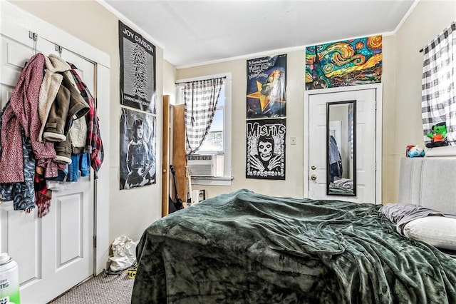 bedroom with carpet, ornamental molding, and cooling unit