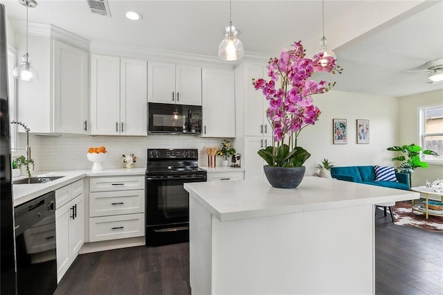 kitchen featuring black appliances, tasteful backsplash, visible vents, and light countertops