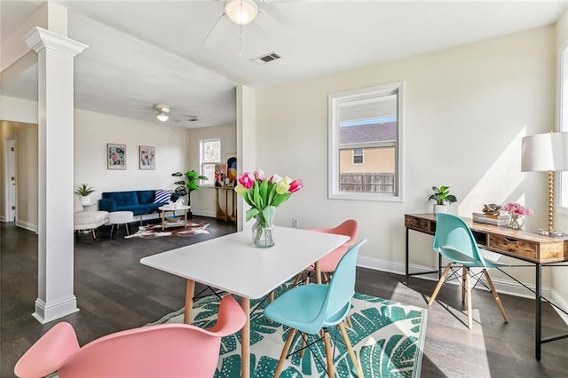 dining space featuring wood finished floors, decorative columns, visible vents, and a ceiling fan