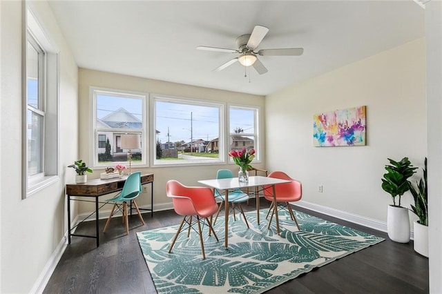 dining space featuring dark wood finished floors, baseboards, and ceiling fan