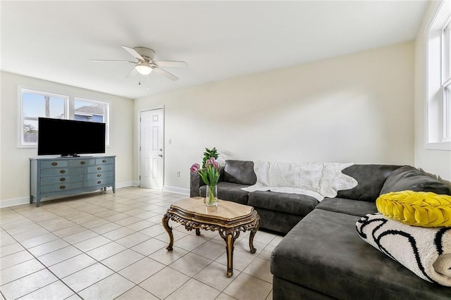 living room with light tile patterned floors, baseboards, and a ceiling fan