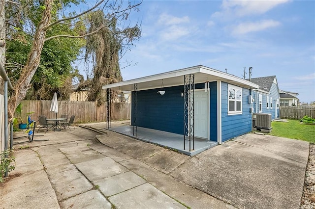 garage featuring fence and central air condition unit