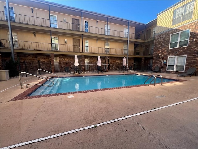 community pool featuring a patio area