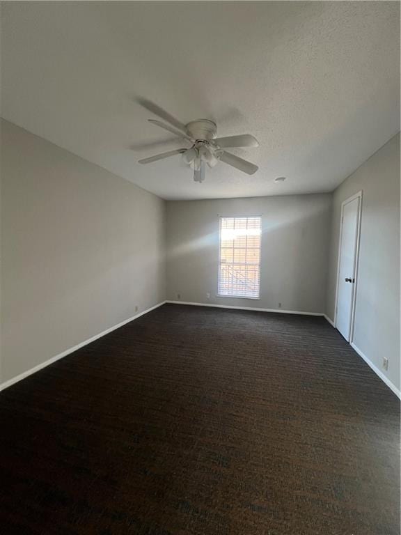 unfurnished room featuring baseboards and ceiling fan