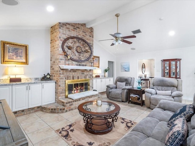 living area with crown molding, vaulted ceiling with beams, visible vents, a brick fireplace, and light tile patterned flooring