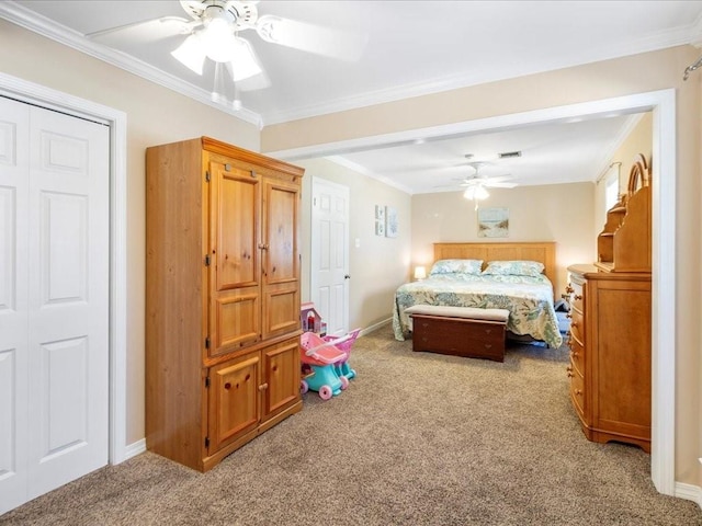 carpeted bedroom with visible vents, crown molding, baseboards, and ceiling fan