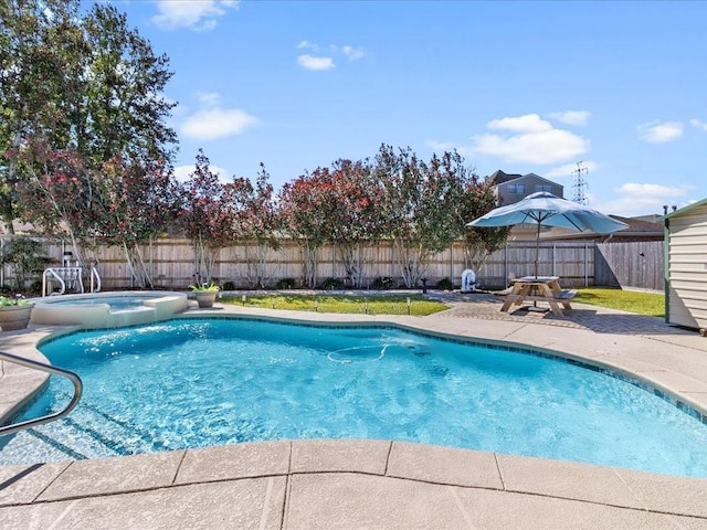 view of swimming pool featuring a patio area, a fenced backyard, and a pool with connected hot tub