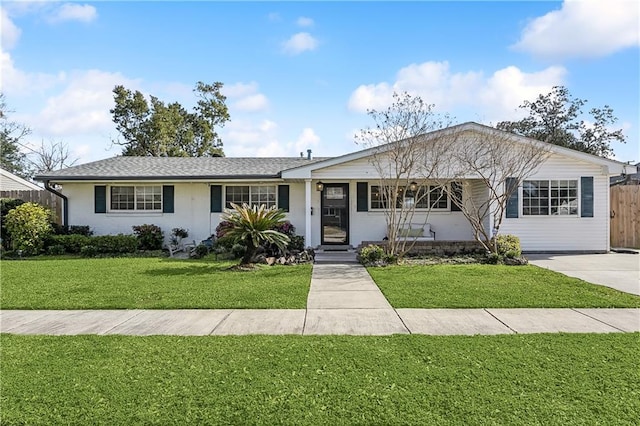 ranch-style home featuring fence and a front yard